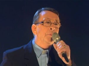 MI-singing-priest-2