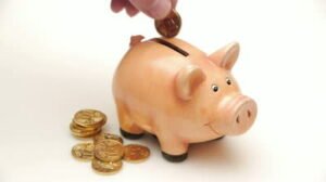 stock-footage-hd-man-throws-a-coin-in-a-piggy-bank