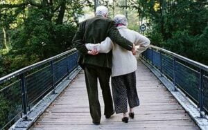 Elderly-couple-walking-across-footbridge-Photo-GETTY