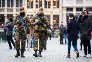 Belgian Army soldiers patrol in the picturesque Grand Place in the center of Brussels on Friday, Nov. 20, 2015.  Salah Abdeslam, a French national who lived in Molenbeek, Belgium, is currently the subject of an international manhunt after the Paris attacks. Security has been stepped up in parts of Belgium as a precaution. (AP Photo/Geert Vanden Wijngaert)