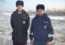 Snow way! Russian policemen help to put out a big fire by throwing snowballs at it